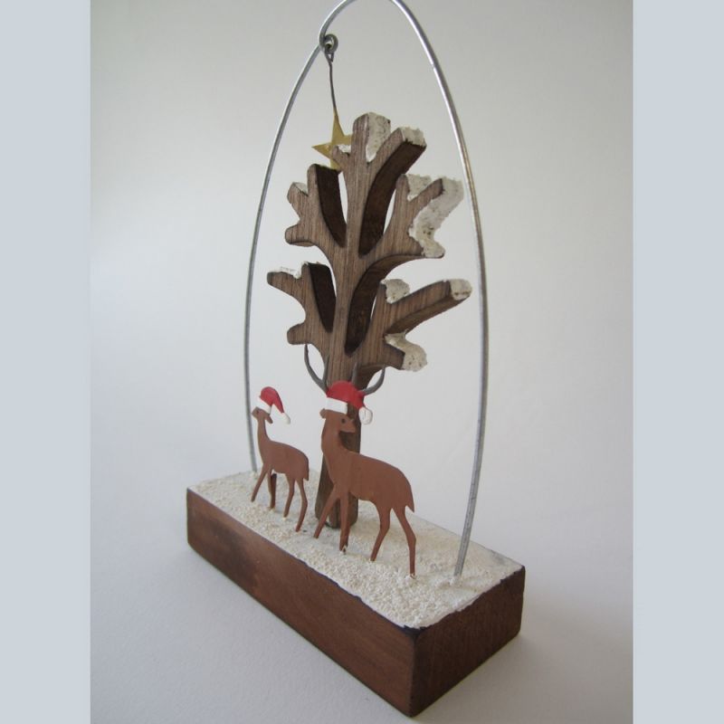 Two deer in hats with tree block