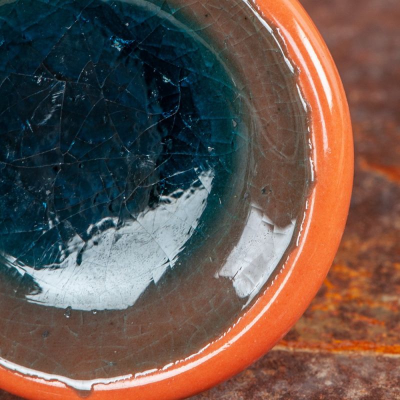 Teal/orange ceramic door knob with crackle glaze