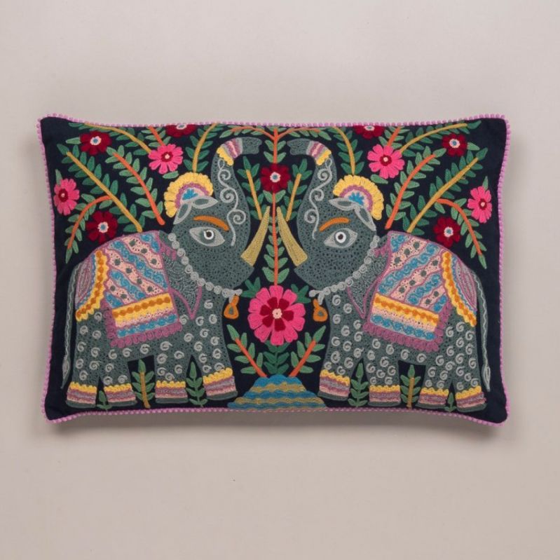 Embroidered elephant filled cushion on dark navy background 